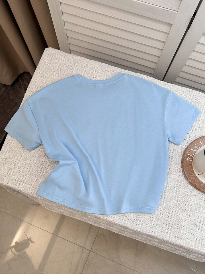 SHEIN تيشيرت صبي شبابي فضفاض بأكمام قصيرة بلون سادة وطباعة حروف إنجليزية